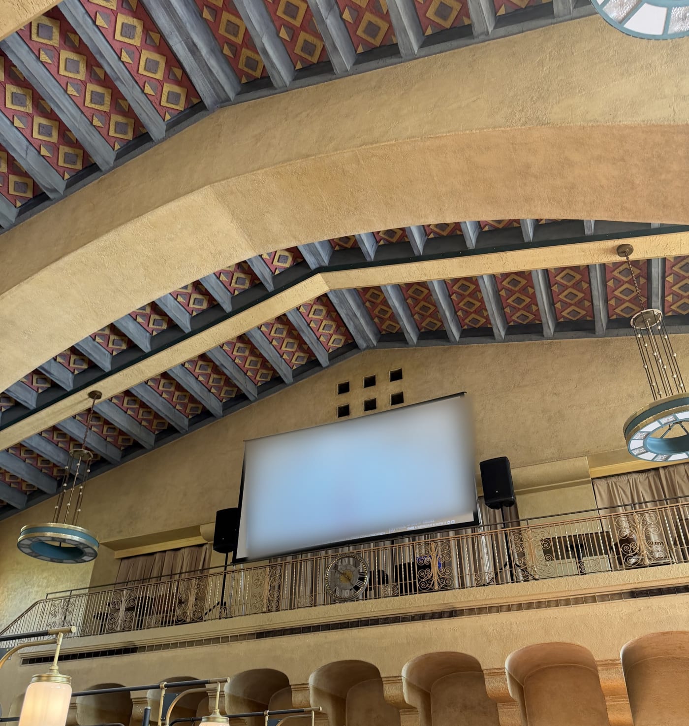 Projection screen and speakers on the balcony of a historic hall at Union Station, Los Angeles