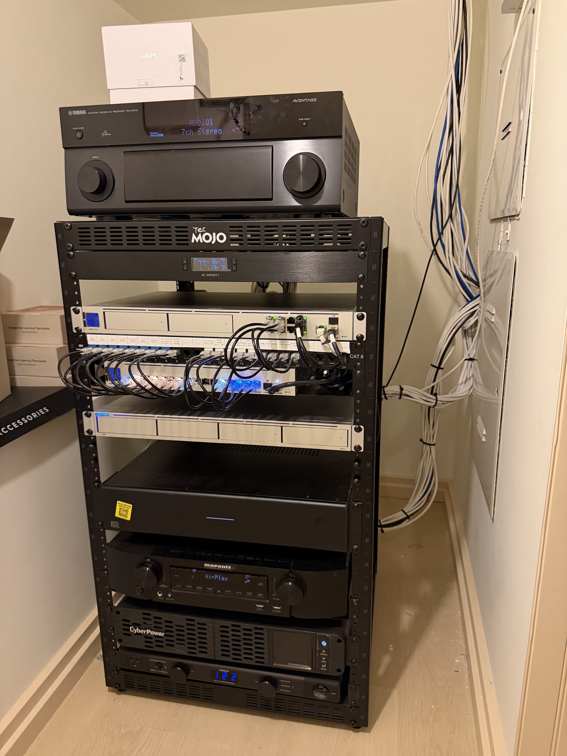 Concealed audio-video equipment rack with amplifiers, receiver and network gear — Ermine Smart Home, Los Angeles
