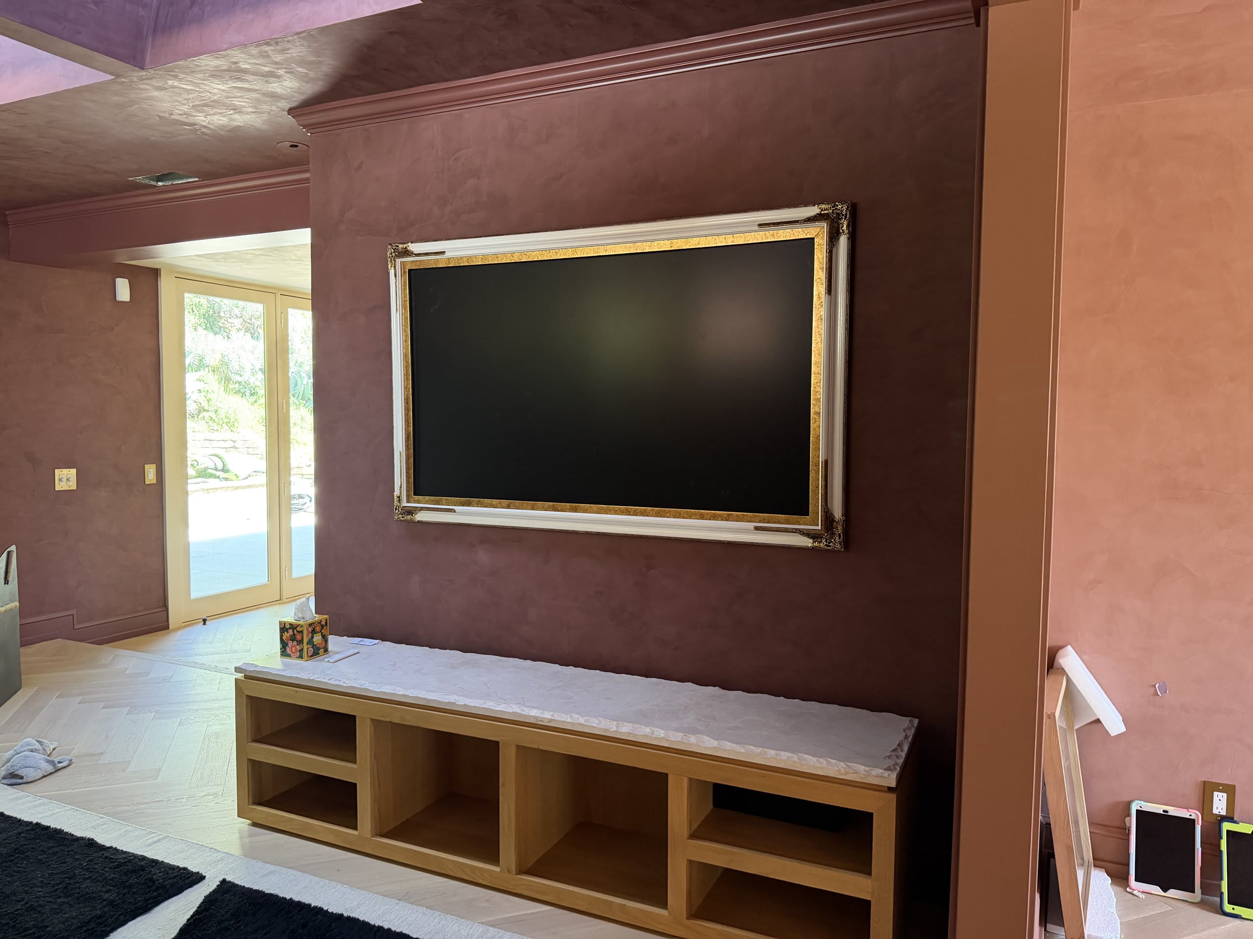 Framed television in art mode on an accent wall, blending into the room's design — Ermine Smart Home, Los Angeles