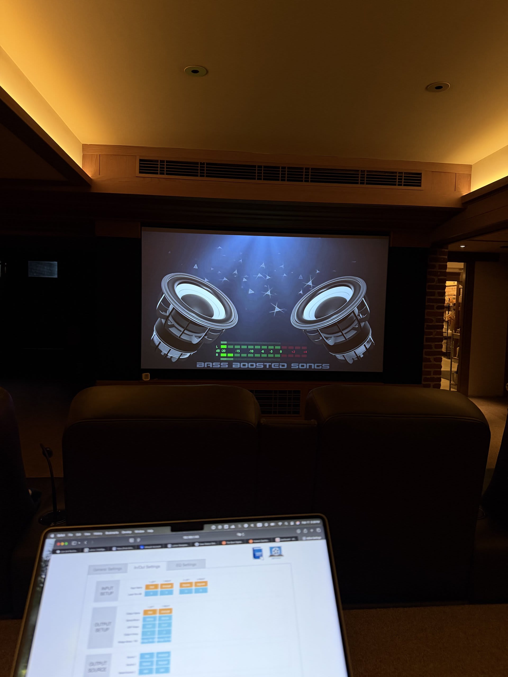 Luxury home theater with tiered seating and a wall-to-wall projection screen — Ermine Smart Home, Los Angeles