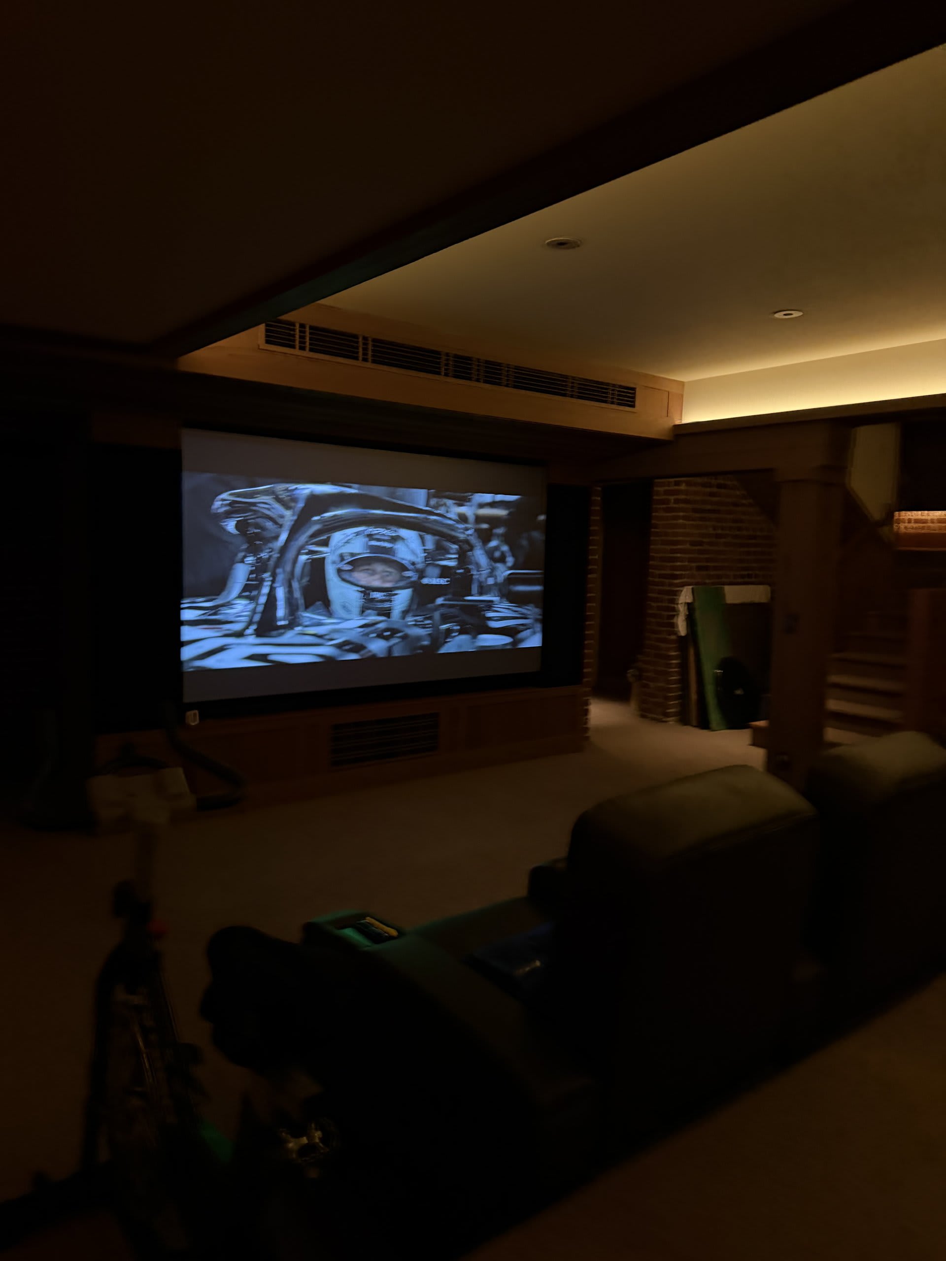 Private home cinema playing a film in an acoustically treated media room — Ermine Smart Home, Los Angeles