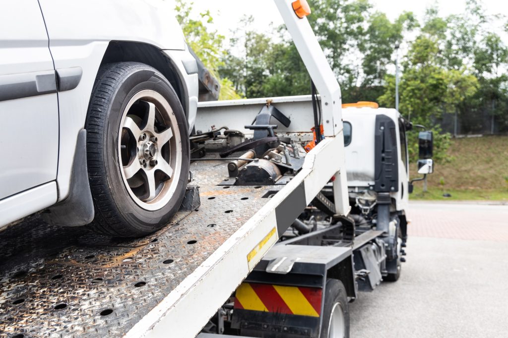 Tow truck picking up a junk car in Pasco County, Florida