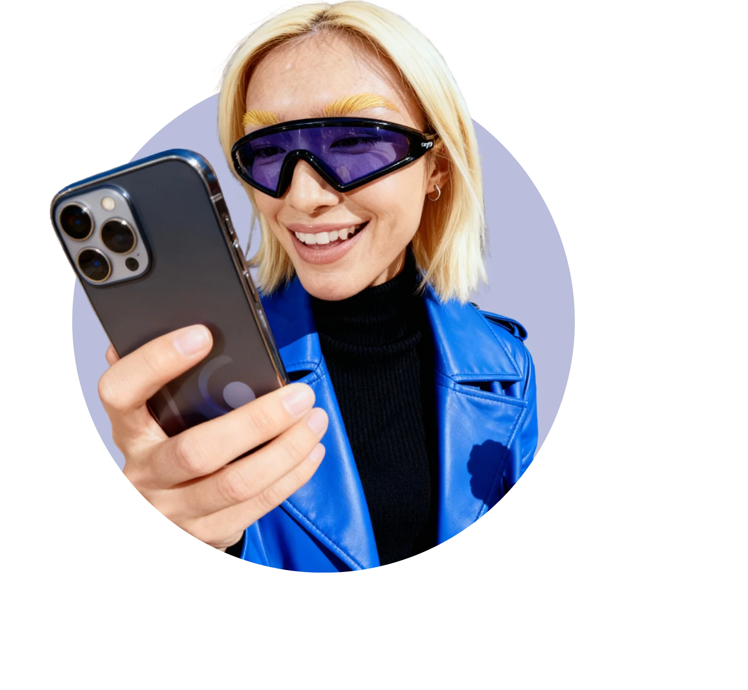 Person in a blue jacket and tinted visor-style sunglasses smiling while looking at their phone against a light circular background.