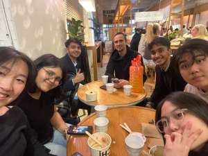 Group of friends dining together at a restaurant table at night