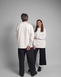 365.APParel Basic Longsleeve Off White — couple in matching basics, man facing away, woman facing camera, studio