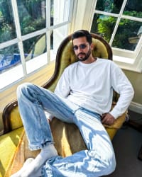365.APParel Basic Longsleeve Off White — man, full body, seated in armchair, sunglasses, indoor