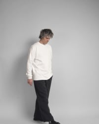 365.APParel Basic Longsleeve Off White — man, full body, three-quarter front view, looking down, studio