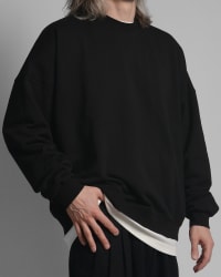 365.APParel Oversize Sweatshirt Black — man, cropped three-quarter front view, hand on hip, studio
