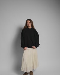 365.APParel Oversize Sweatshirt Black — woman, full body front, smiling, pleated maxi skirt, studio