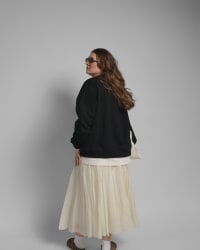 365.APParel Oversize Sweatshirt Black — woman, full body three-quarter back view, sunglasses, tote bag, pleated maxi skirt, studio