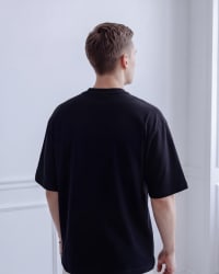 365.APParel Oversize T-shirt Black — man, full body back view, standing, indoor editorial
