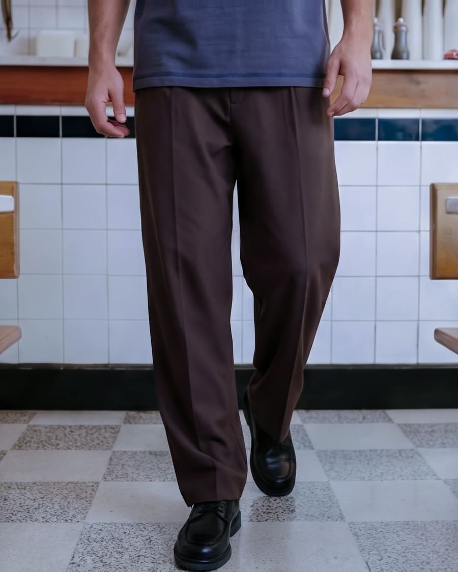 365.APParel Basic T-shirt Graphite — man, cropped lower body, walking, café interior, indoor