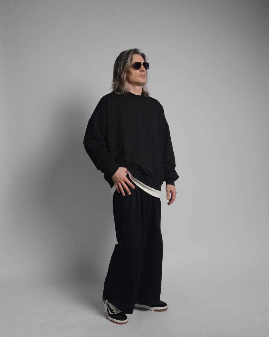 365.APParel Oversize Sweatshirt Black — man, full body three-quarter side view, sunglasses, long silver hair, hand on hip, studio