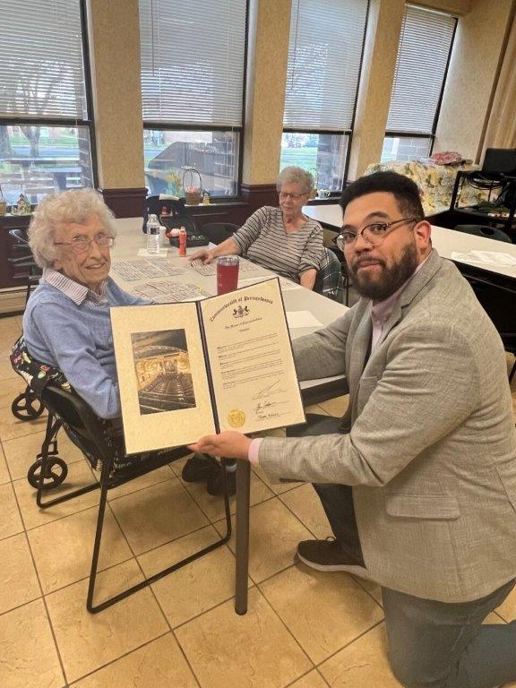 Rep. Manny Guzman with community member