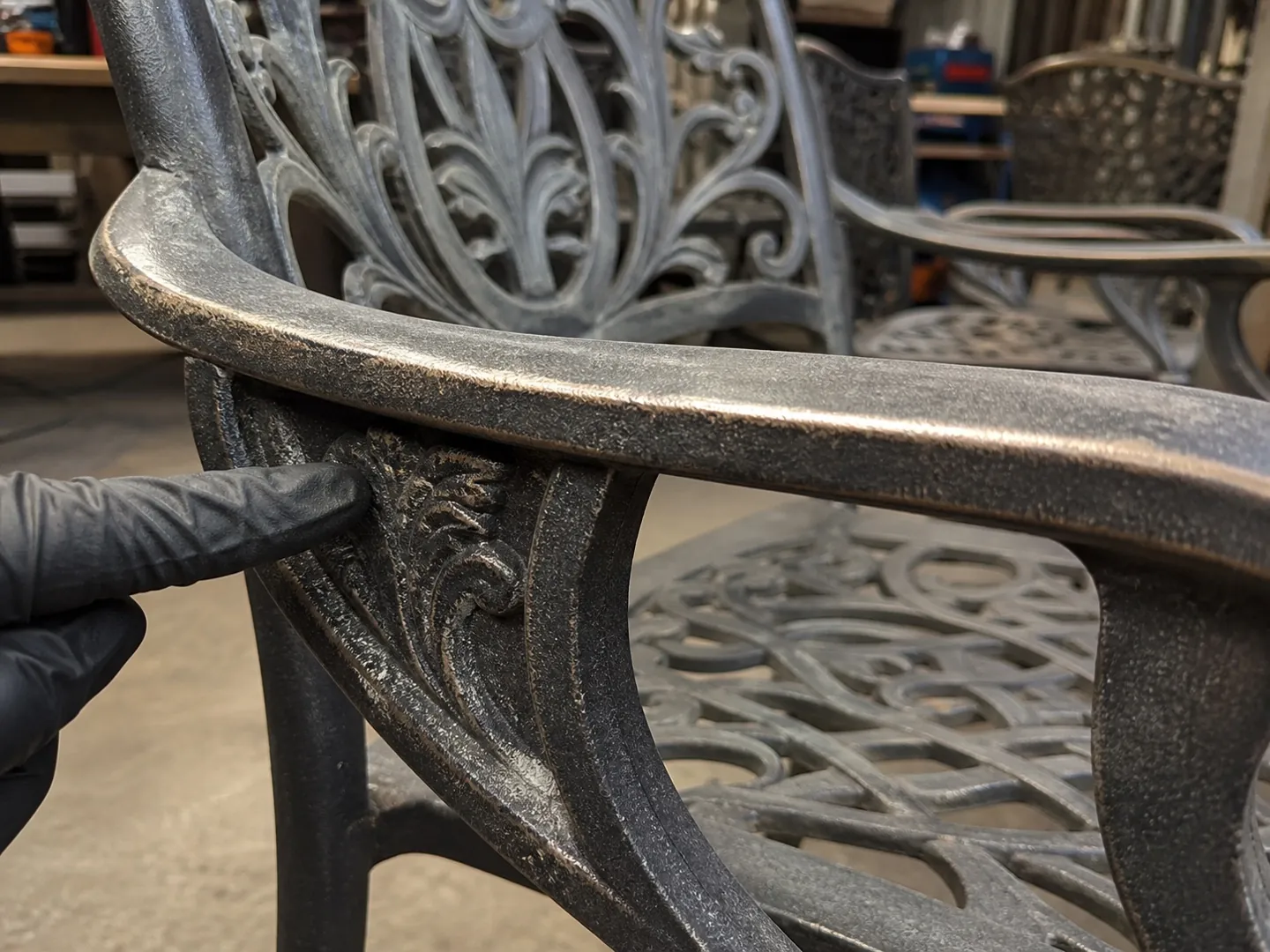Close-up of weathered decorative cast aluminum furniture detail