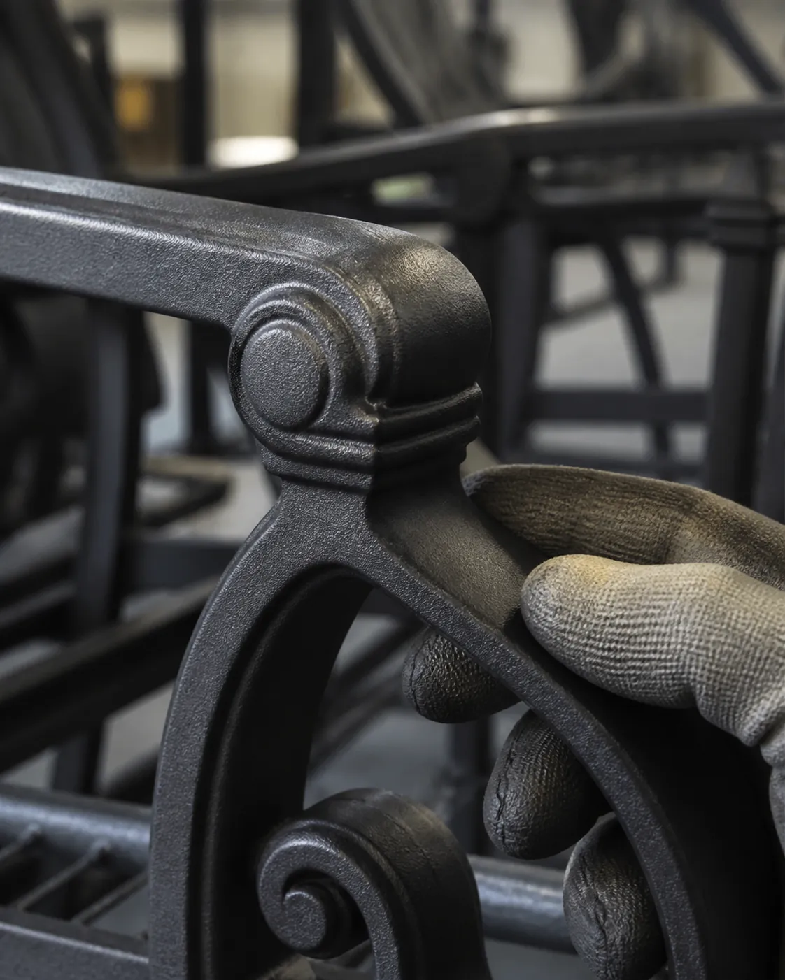 Detail of a refinished metal furniture surface being visually checked