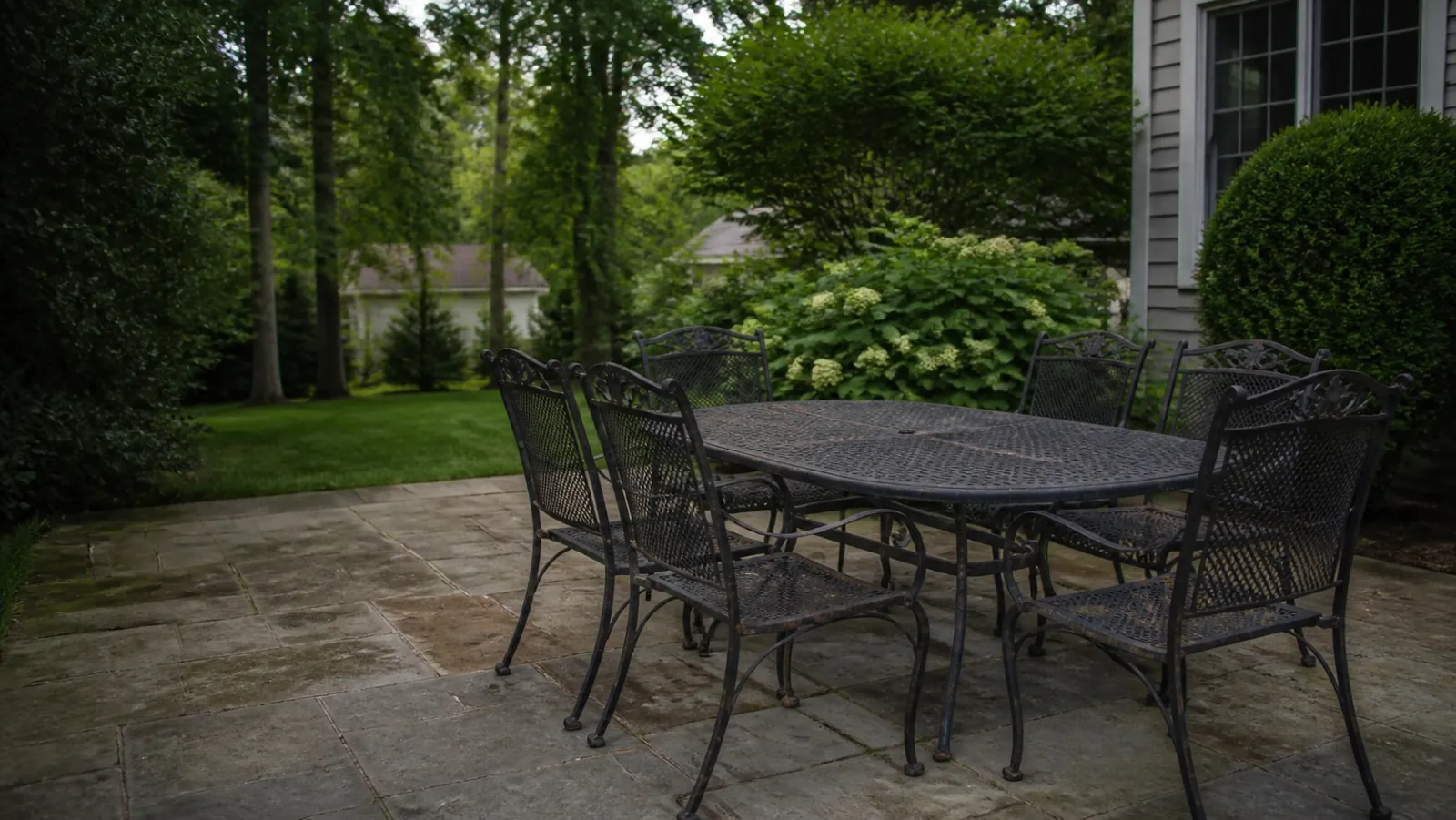A weathered metal patio dining set at a New Jersey home