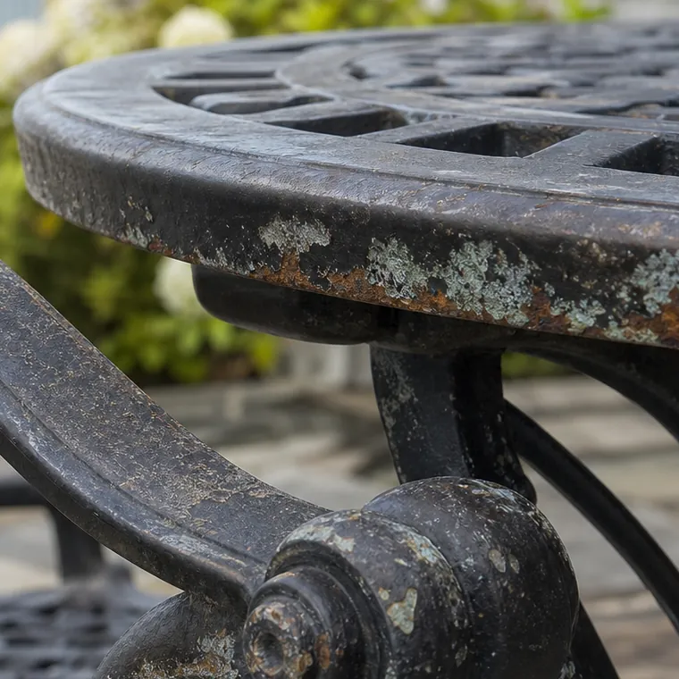 Close view of weathered metal patio furniture