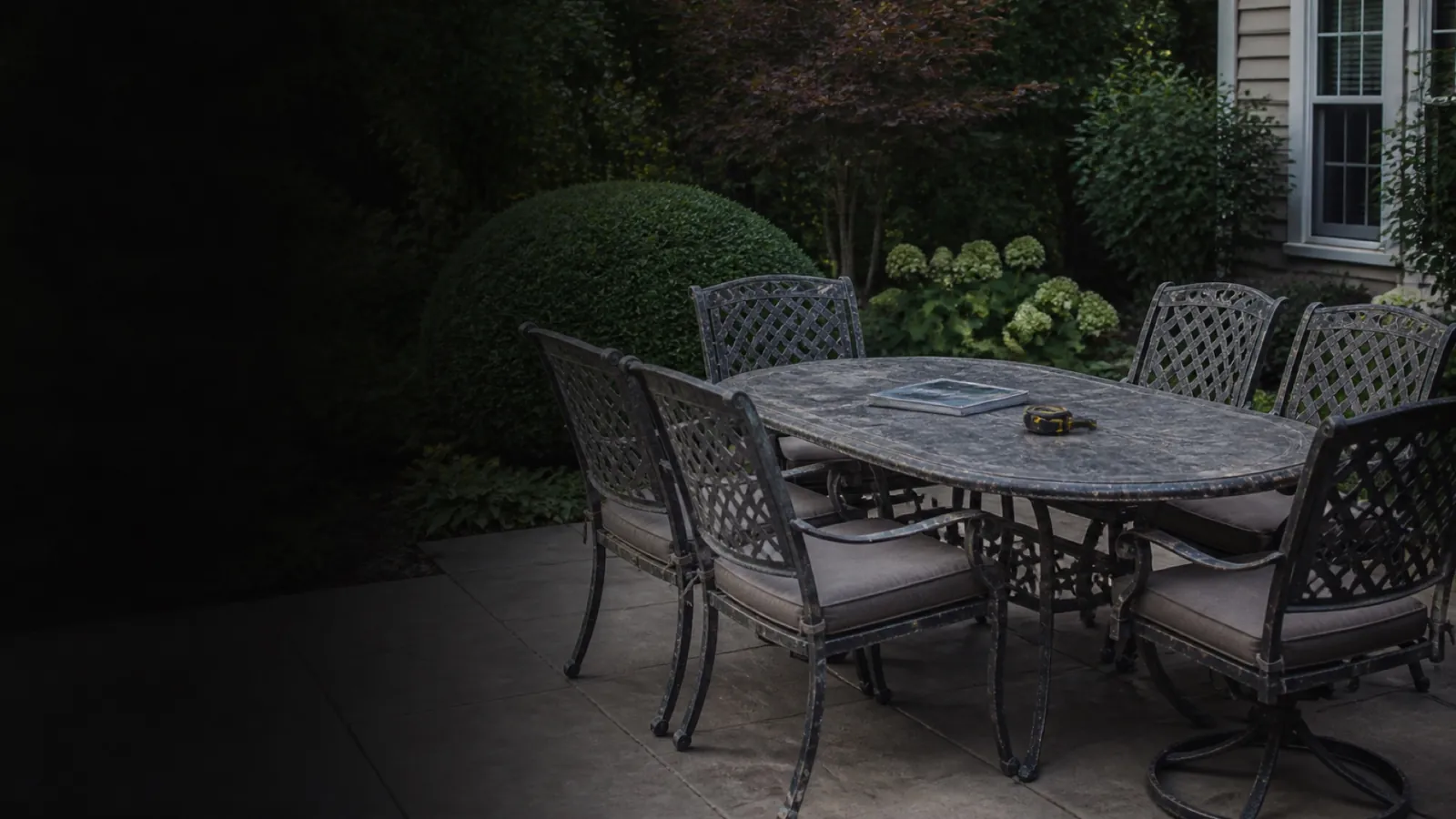 A coordinated weathered metal patio dining set