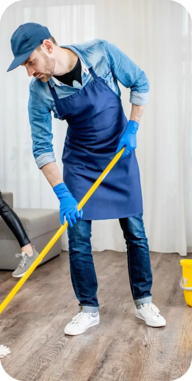 Cleaner mopping a wooden floor in a living room