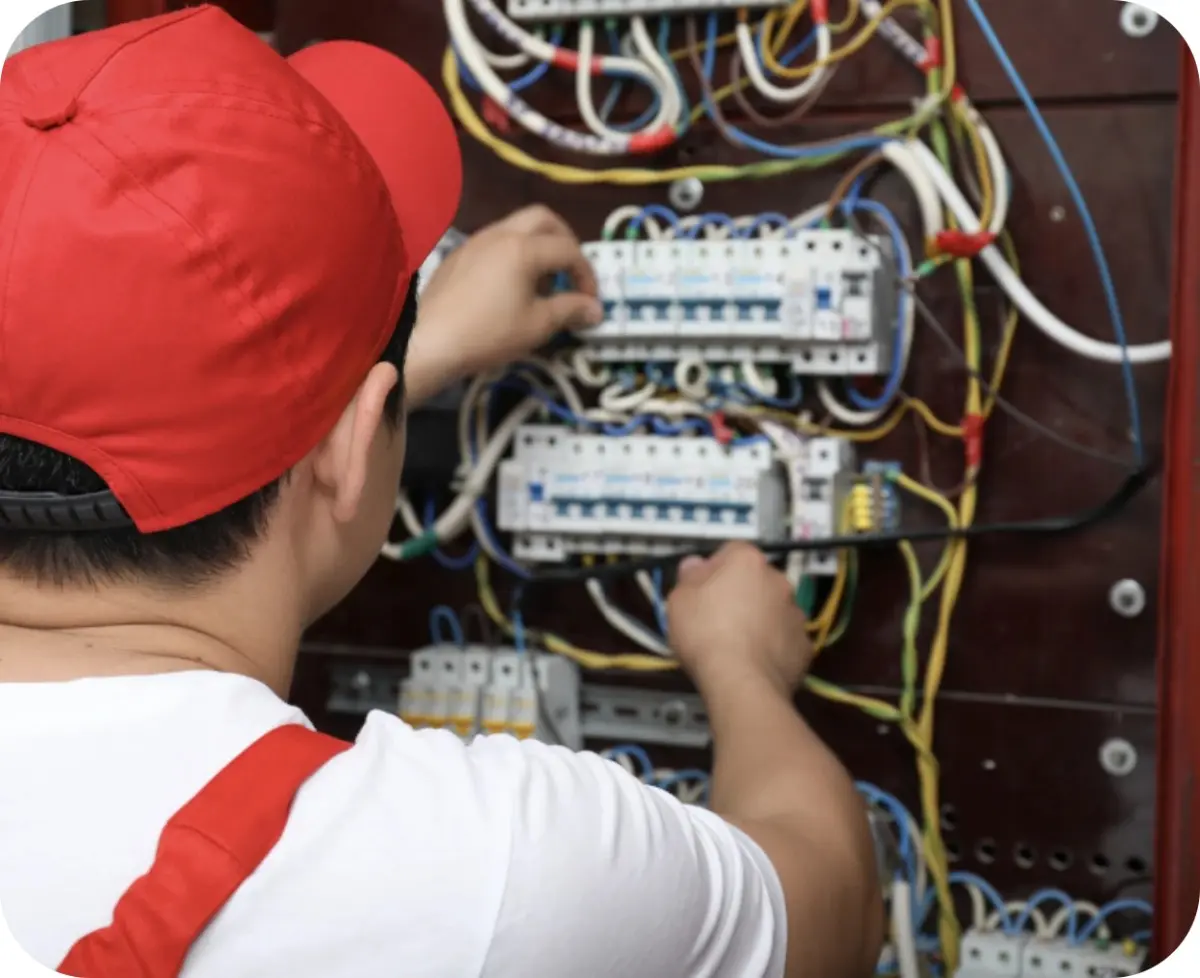 Electrician adjusting wires in an electrical panel