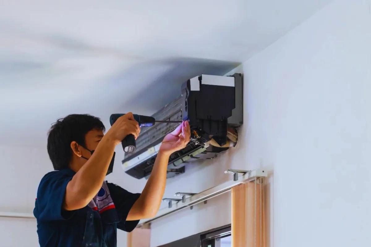 HVAC technician installing an air conditioner unit