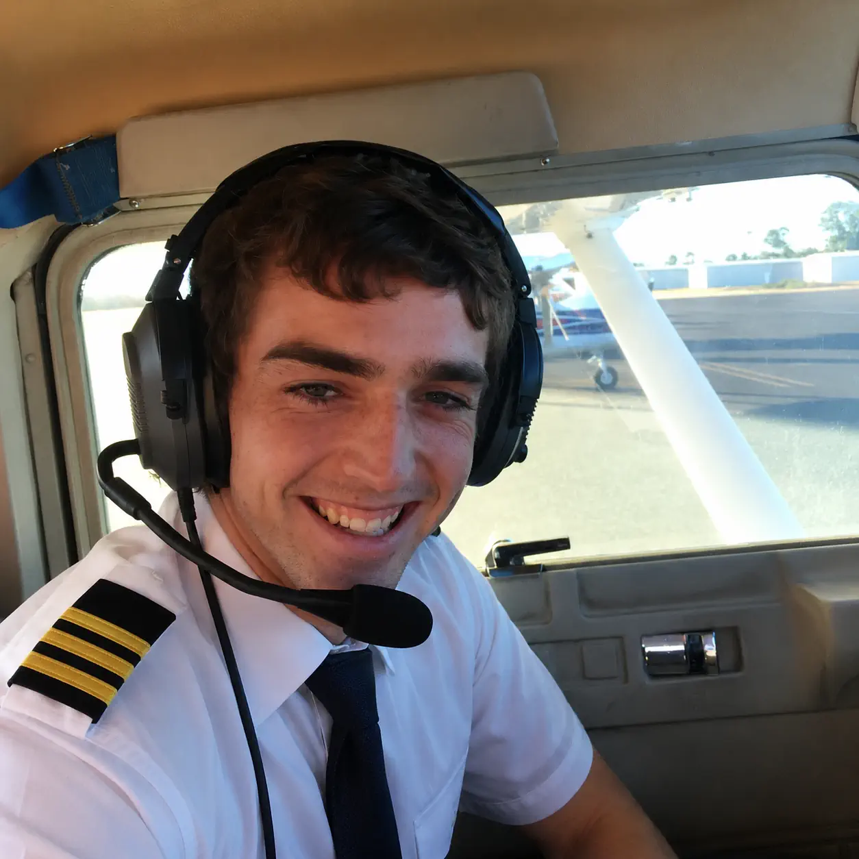TFA student pilot smiling in the aircraft before training