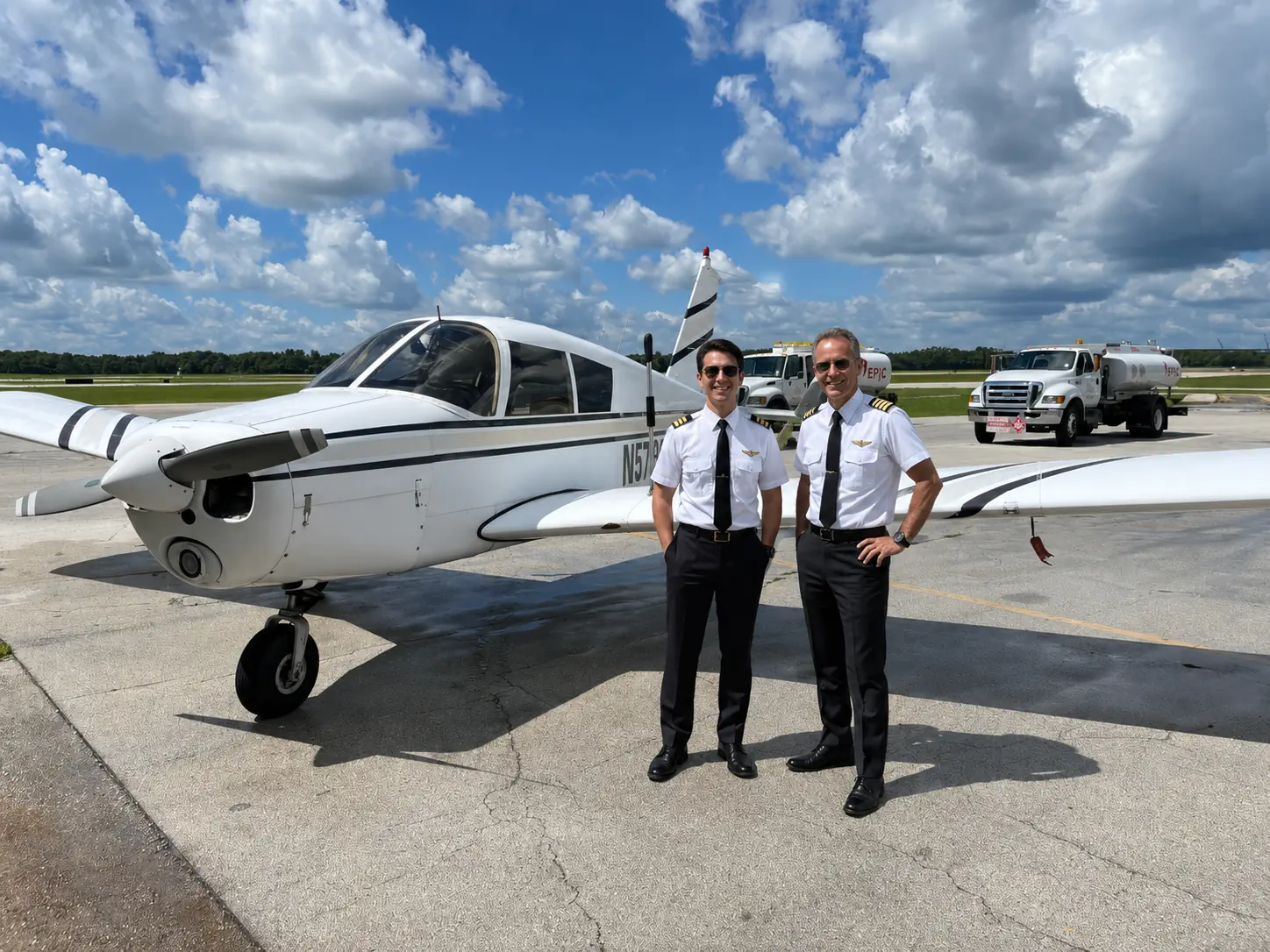 TFA instructors standing beside a training aircraft