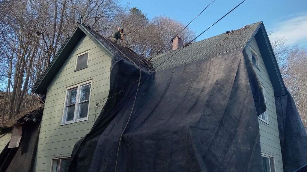 Tarp-covered house, used for protection in exterior renovations