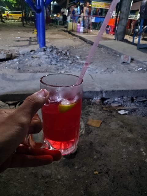 Holding a drink near Kyauk Myaung market, Yangon