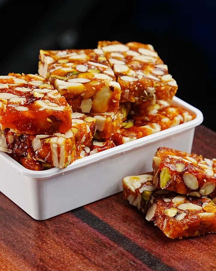 Cashew and nut brittle stacked on a wooden board