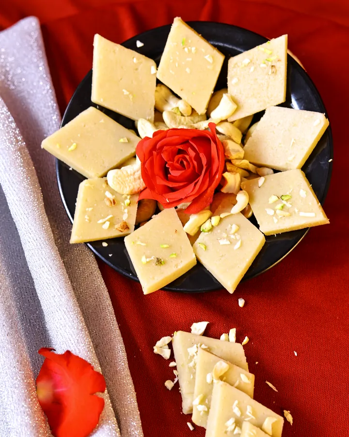 Kaju katli arranged on a dark plate