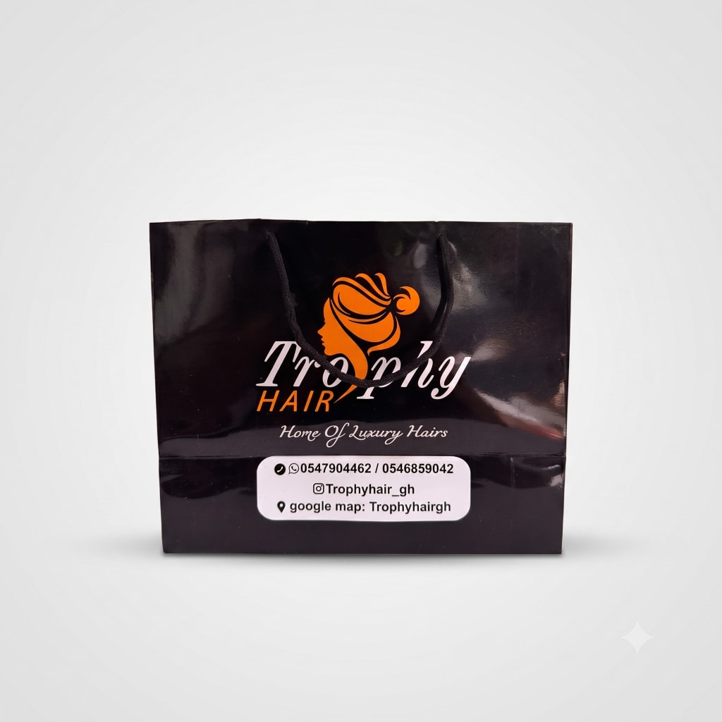 Trophy Hair — glossy black wide luxury bag with rope handles and orange logo.