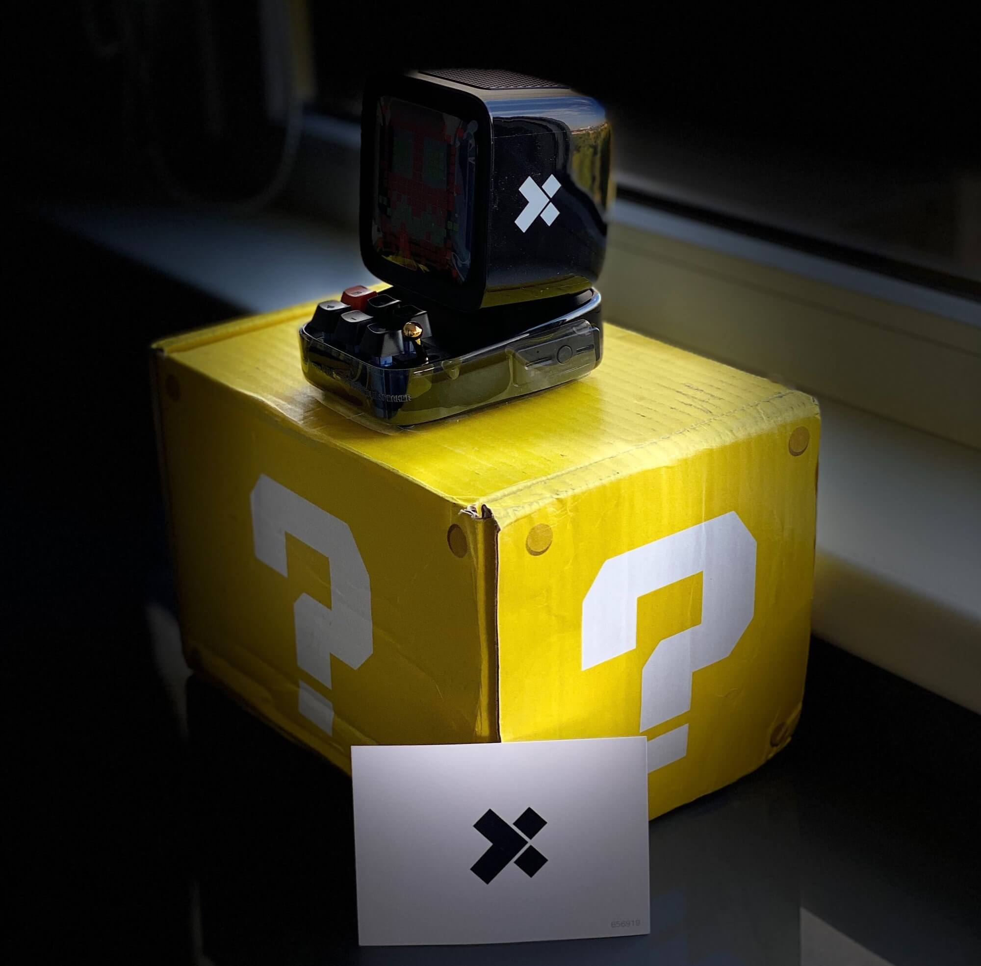 a box with a question mark, an X-Team envelope, and a Gameboy-ish device