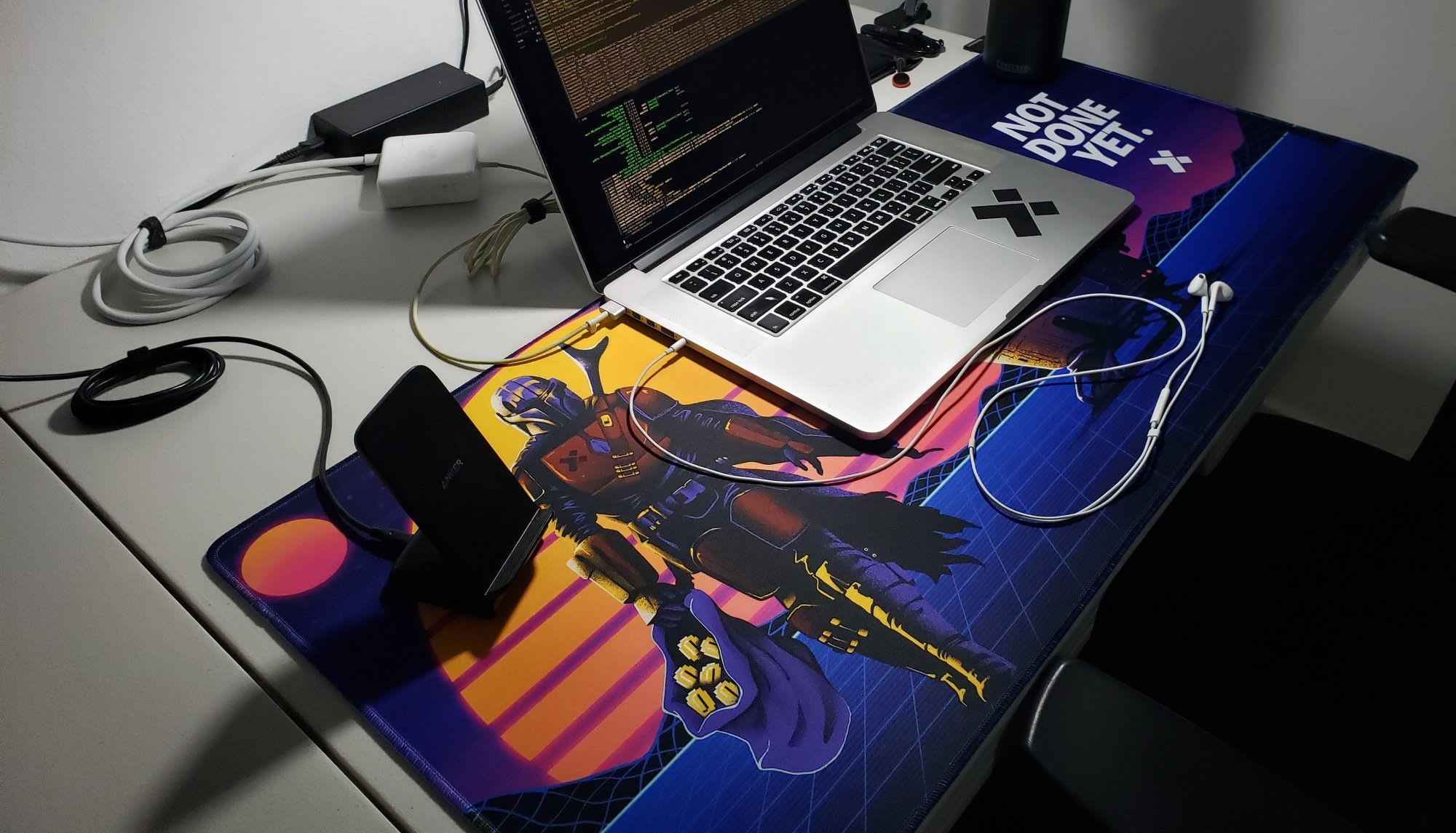 a desktop mat with a smartphone and a laptop on it