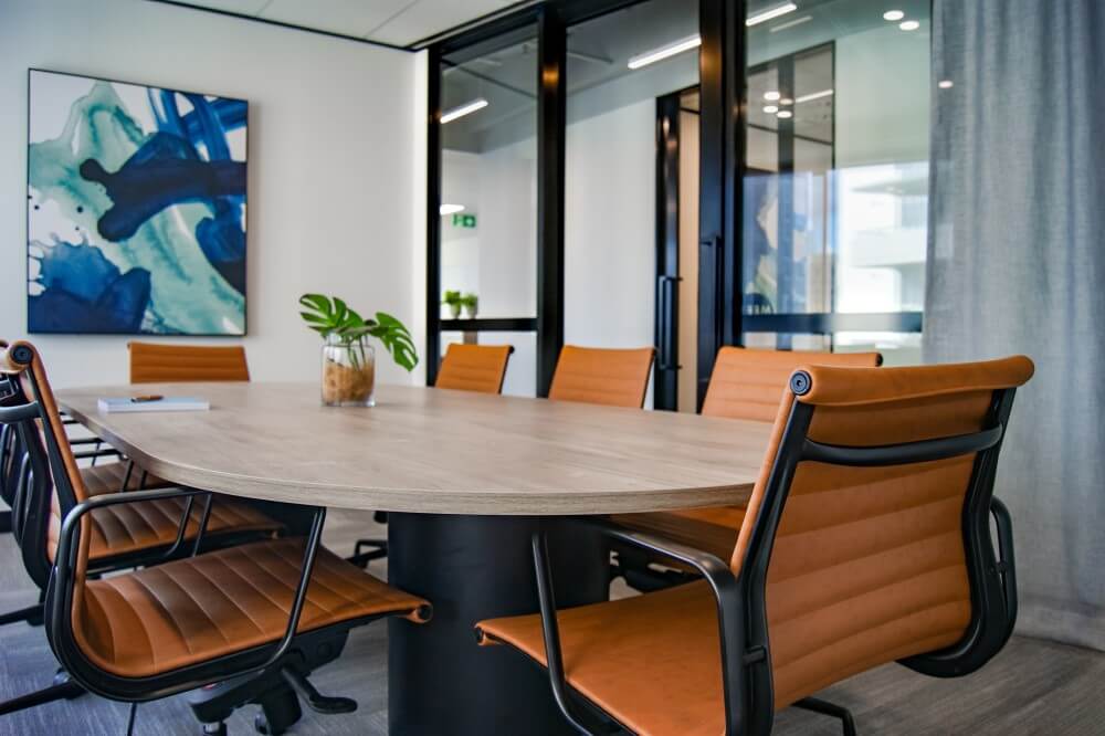 A conference room with a table surrounded by chairs