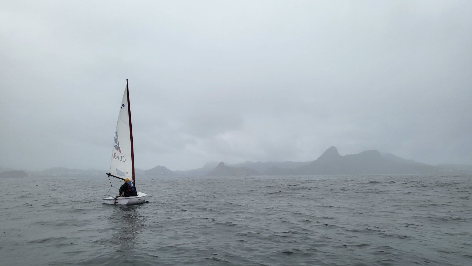 A small sailboat in the mist