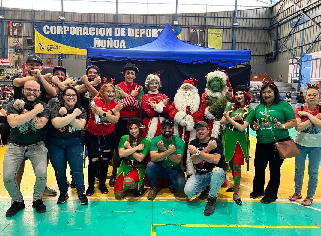 a group of people dressed up as Santa and the Grinch crossing their arms in an X