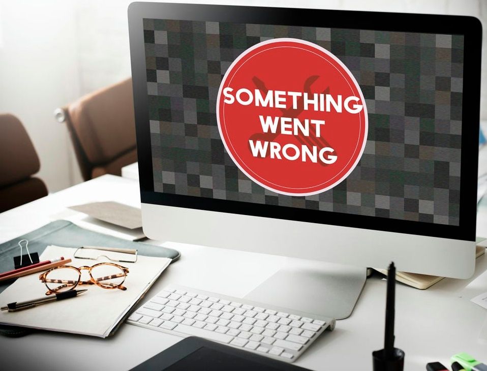 A computer screen displays an error message in a modern office setting.