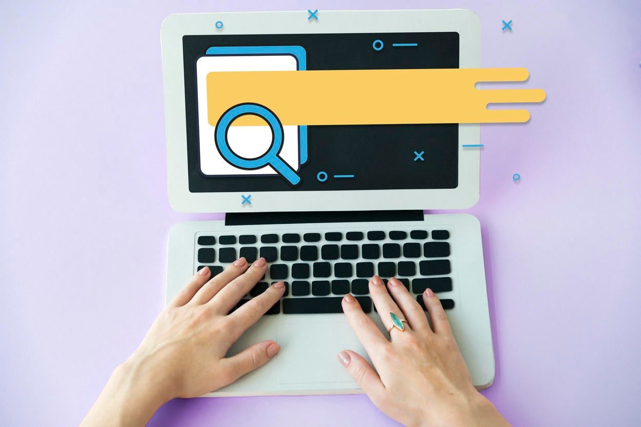 The image shows hands typing on a laptop with a search icon and a highlighted search bar on the screen, representing the process of conducting an online search or research.