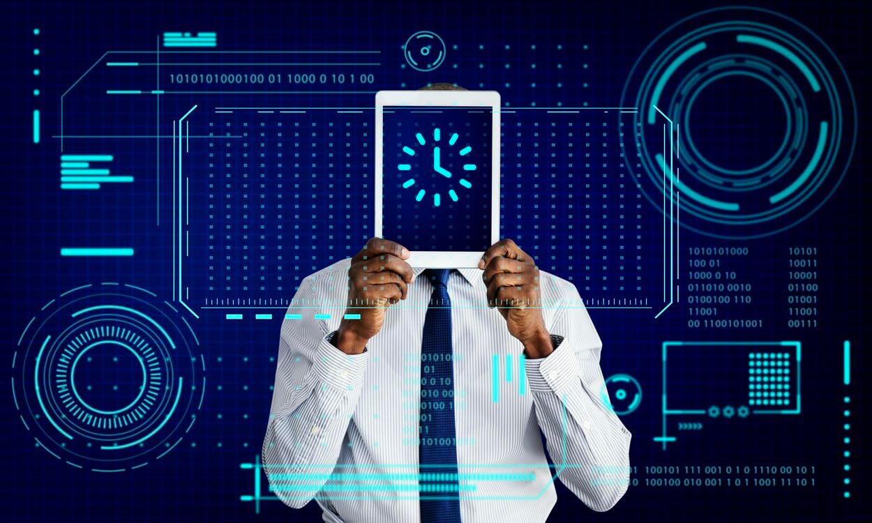 The image shows a man in a business suit holding a digital tablet displaying a clock, integrated into a futuristic interface with digital graphics and binary codes.