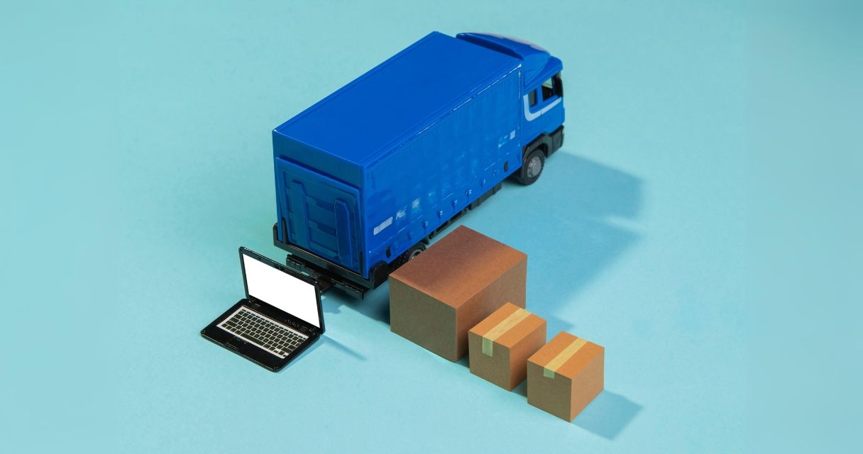 This image shows a miniature delivery truck linked to a laptop, representing the digital integration in logistics.