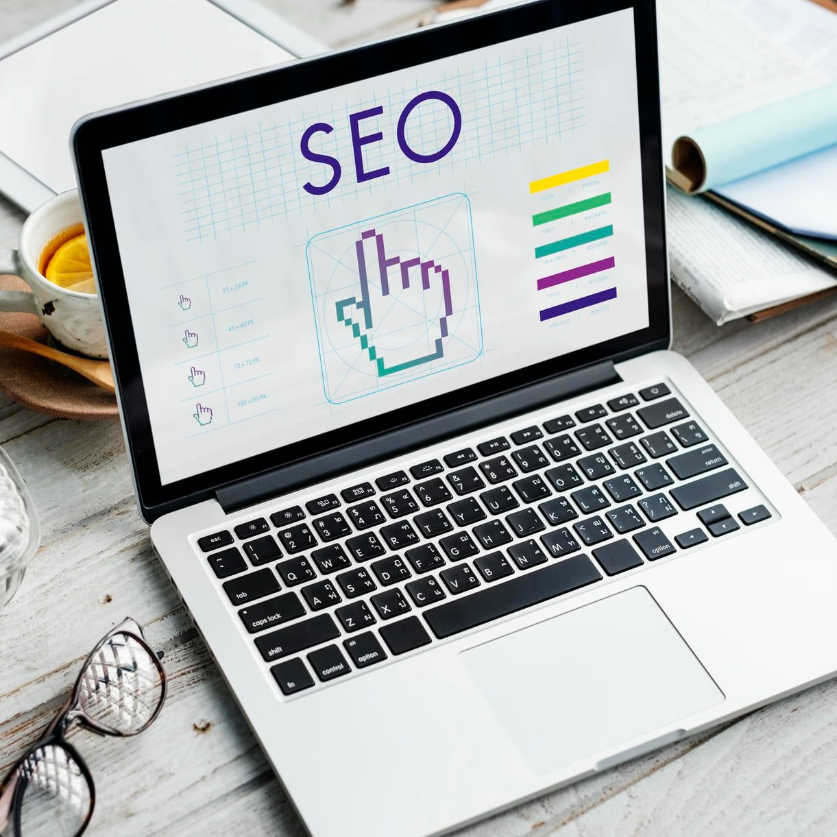 The image displays a laptop screen showing a graphic about SEO (Search Engine Optimization), featuring various metrics and data visualizations to illustrate website performance and ranking strategies.