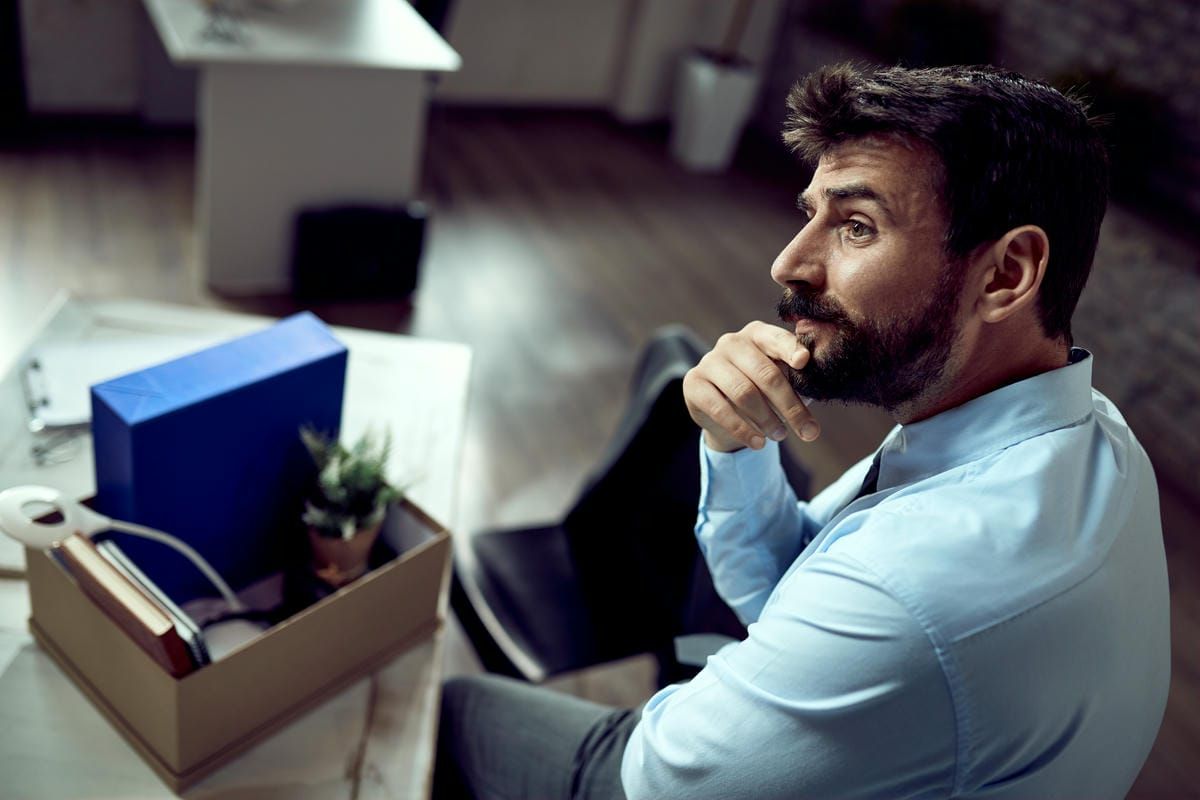 Young pensive businessman thinking in the office after losing his job