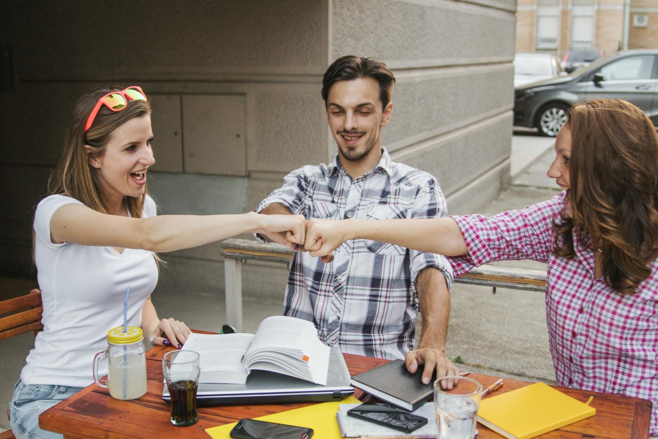 Young people stacking hands