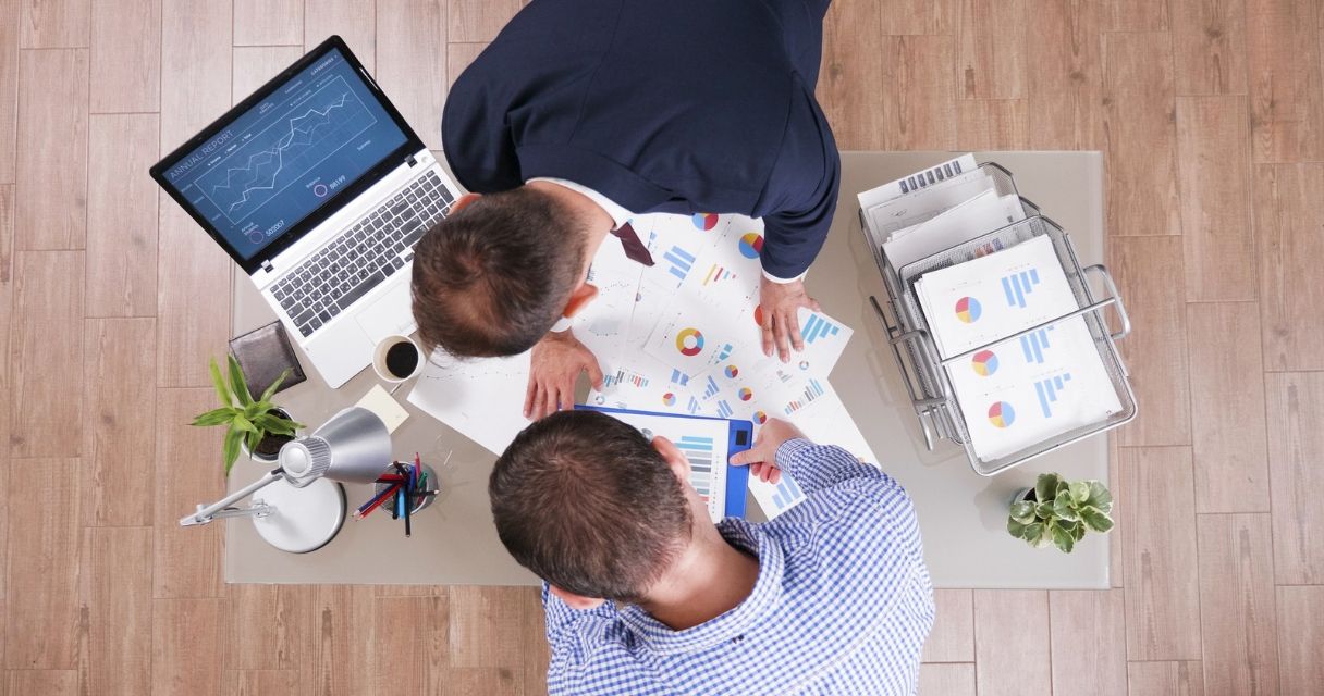 Top view of businessmen working at company strategy analyzing management paperwork