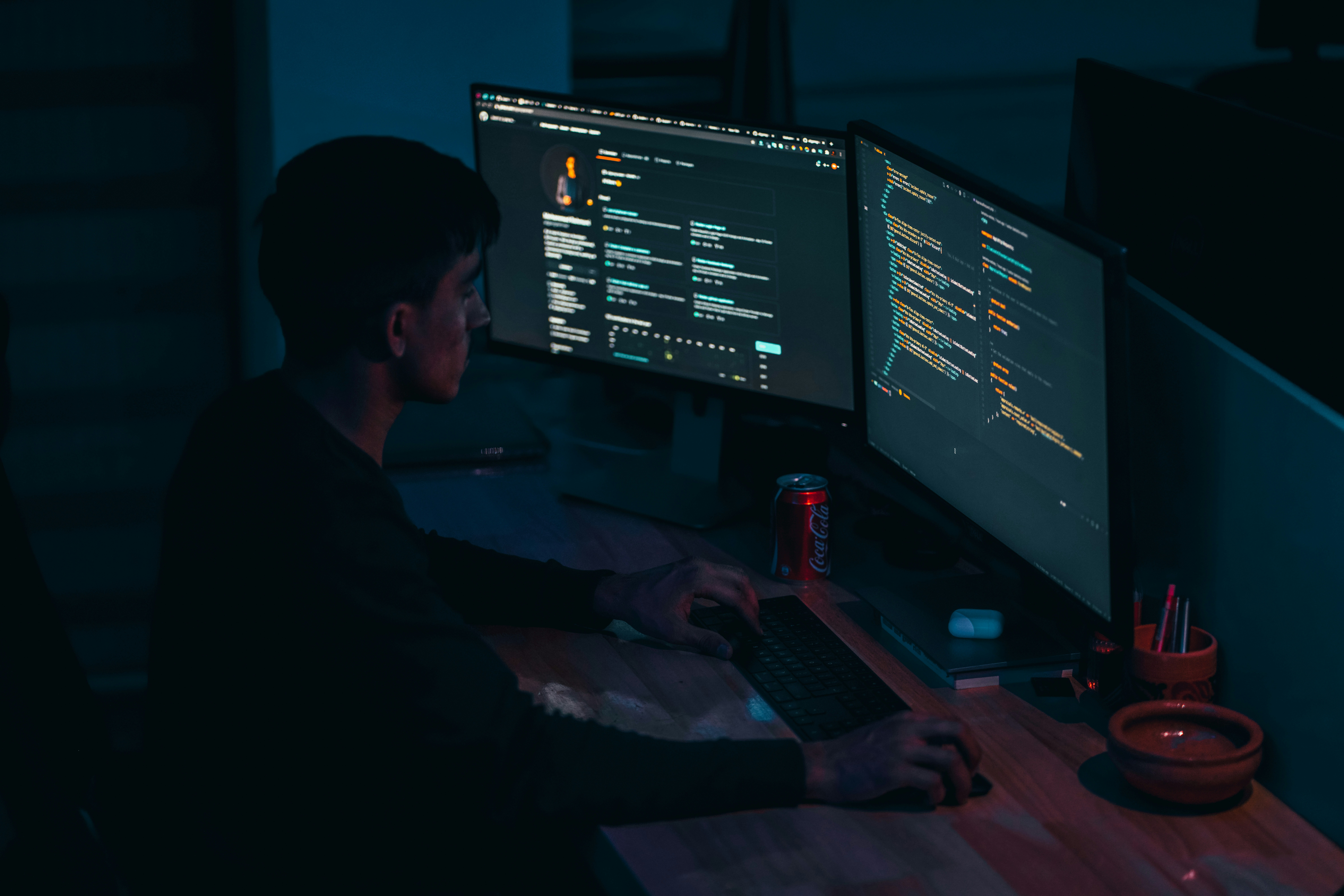 Developer reviewing AI-generated source code on a monitor with code complexity metrics and quality warning dashboard displayed alongside