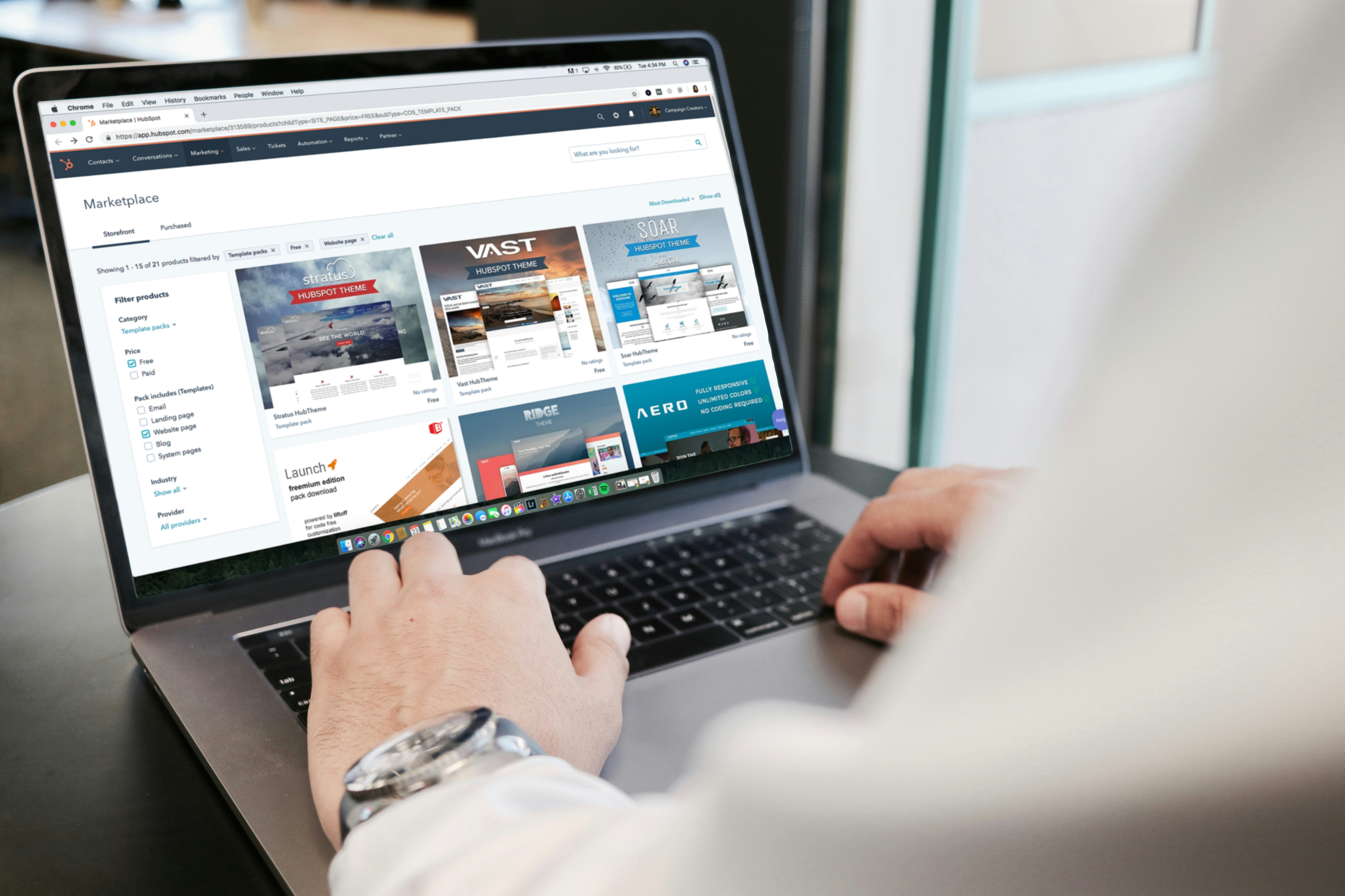 Person using a laptop for checkout extension development