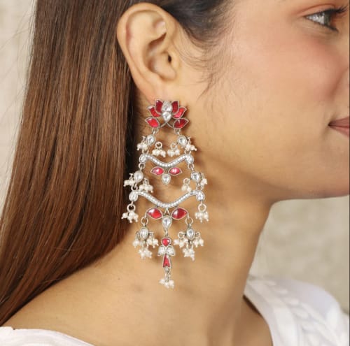 Close-up of a floral design pure silver necklace and earring set