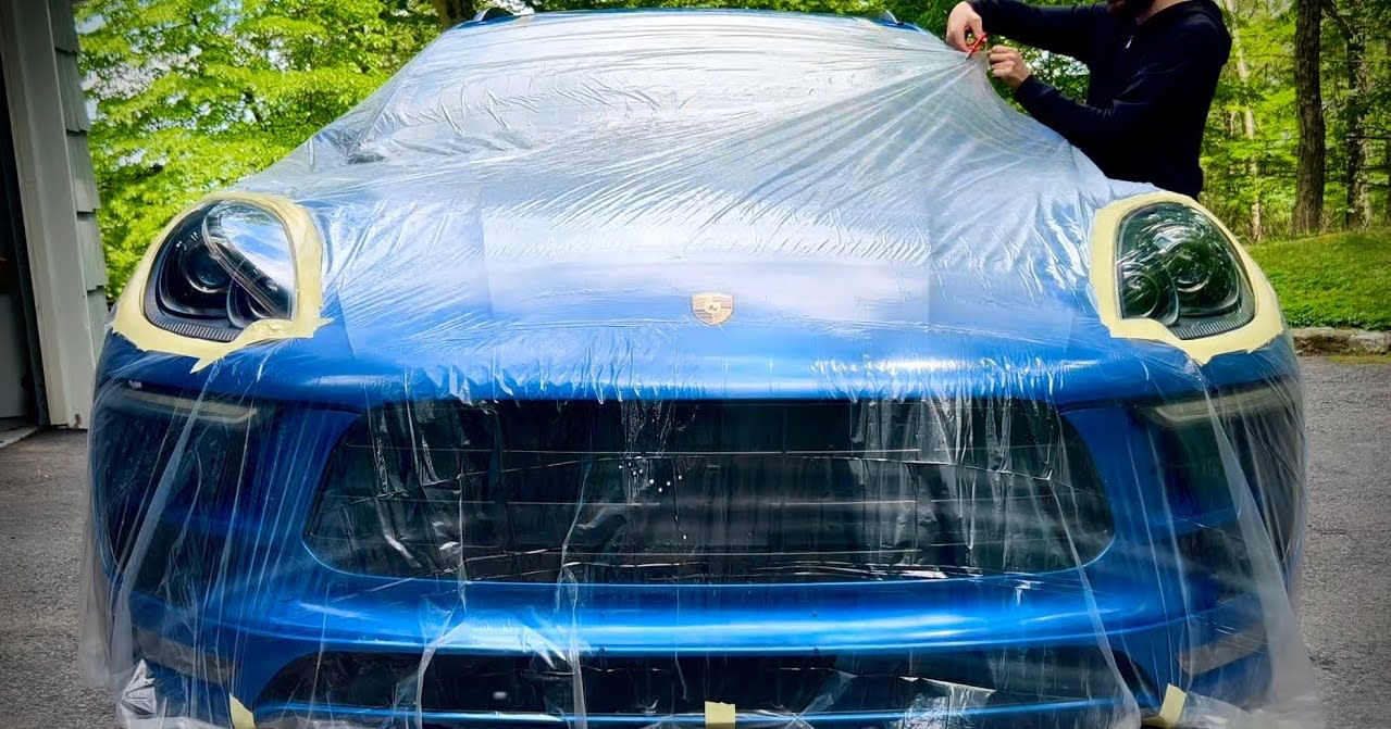 Blue Porsche Macan wrapped in the protection foil before headligh restoration